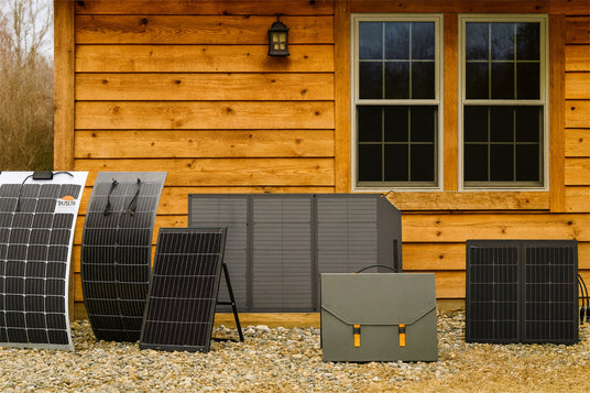 Portable solar panels in front of a wooden cabin